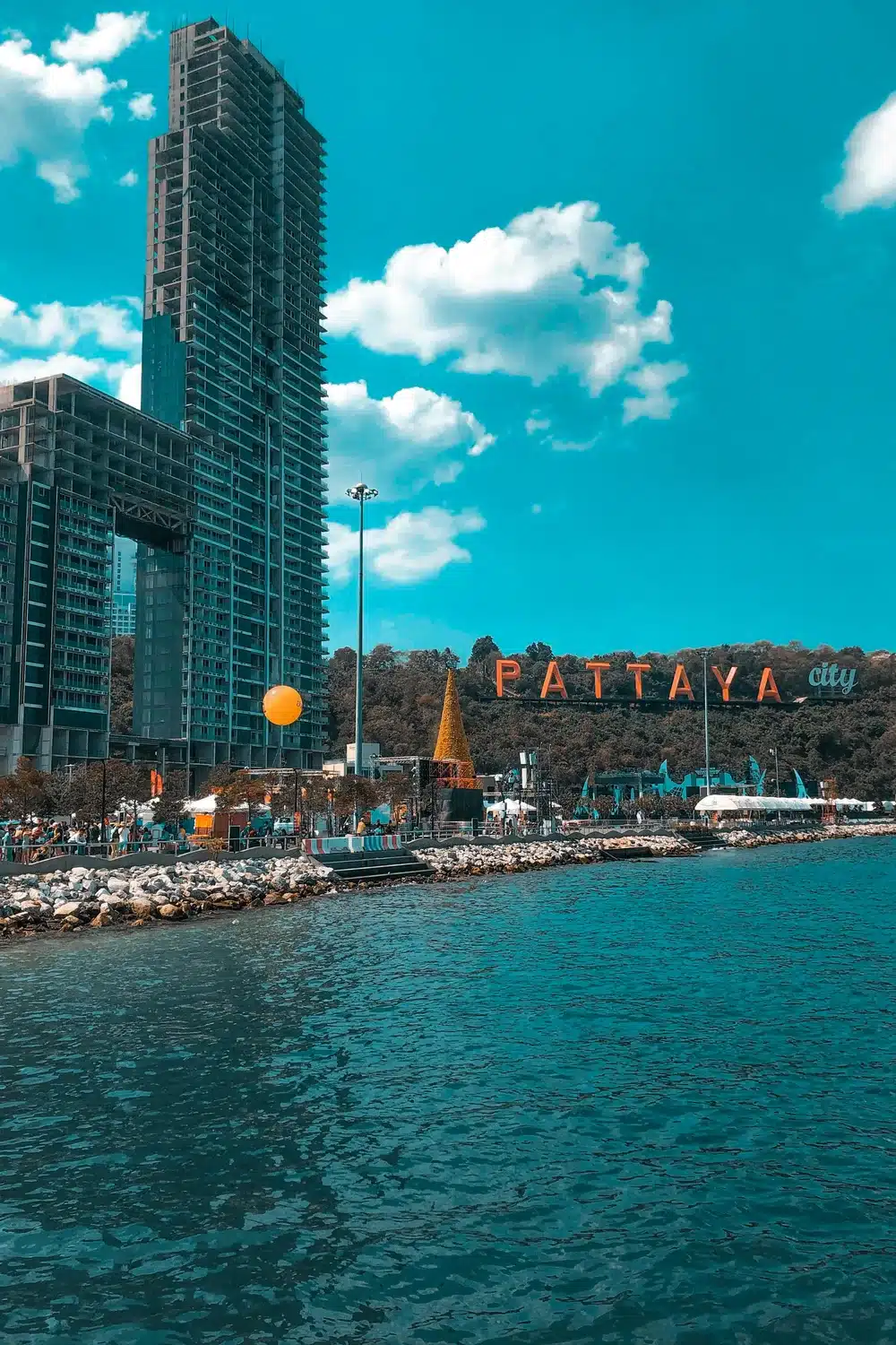 Pattaya city skyline and waterfront with the illuminated Pattaya City sign