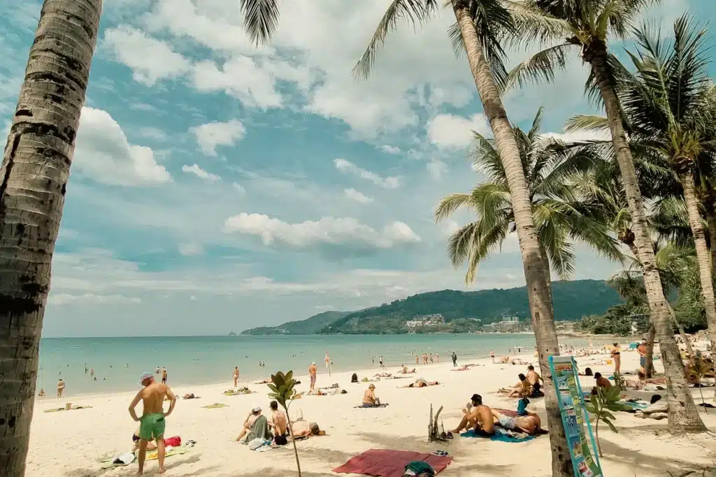 Patong Beach in Phuket with palm trees and sunbathers